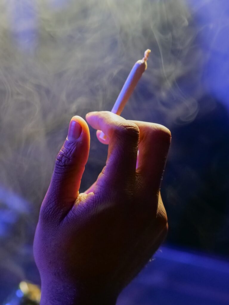 Person Holding White a Joint